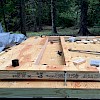 Sheathing the top of the window wall while it's still laying down.