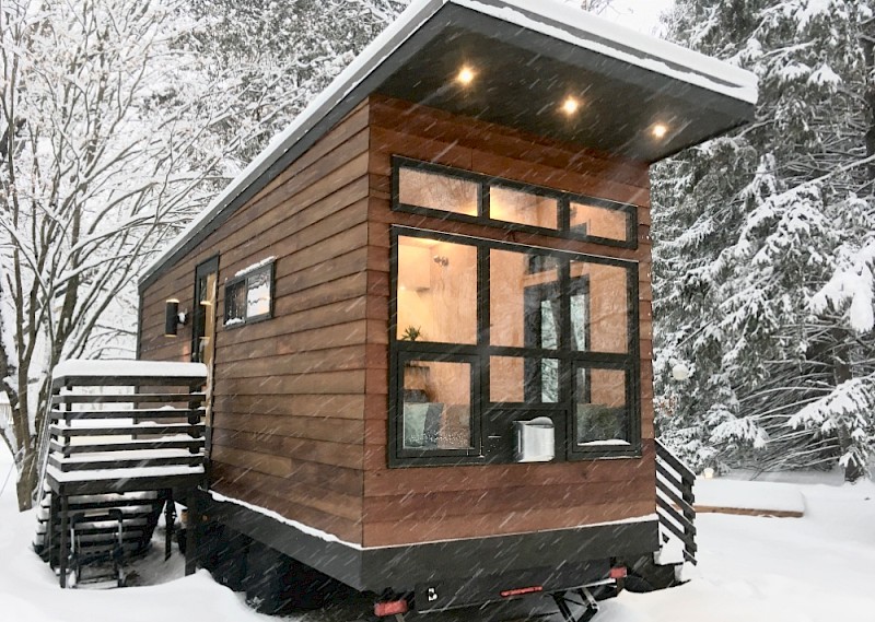 Cold-climate tiny house on wheels in the snow